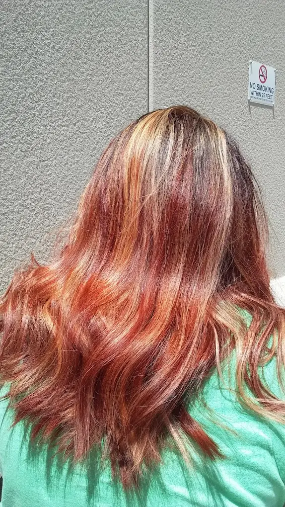 Copper, cherry and blonde highlights blended through long layered hair