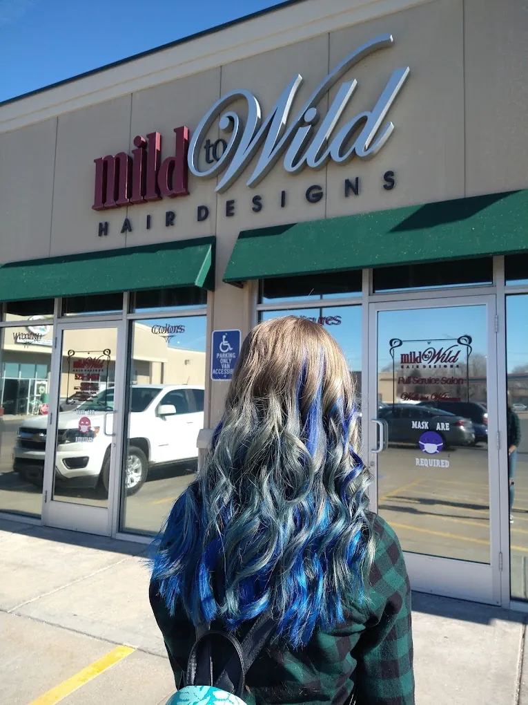 Client with silver and blue blended colour standing outside the Mild to Wild Hair Designs storefront